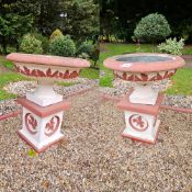 A pair of painted stoneware garden planters raised over square shaped bases, 56cm dia, 66cm high.