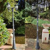 A pair of contemporary lampposts each having twin sconces 222cm high.