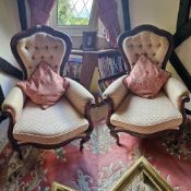 A pair of button back mahogany framed chairs with loose cushions.