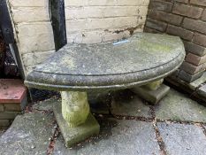 A semicircular cast concrete bench twin supports, 110cm wide.