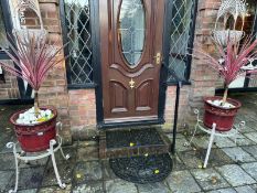 A pair of red glazed garden pots raised over metal bases, 40cm dia, 70cm high. Includes plants.