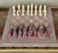 A decorative 20th century continental style chess board with full complement of pieces, 60 x 60cm