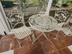 A garden bistro table and twin folding chairs, table 76cm dia.