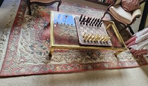 An oriental red ground floral themed woollen rug, 294 x 183cm.