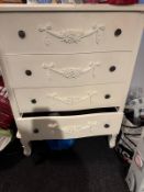 A contemporary white painted chest of four drawers, together with a small matching bedside table.