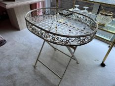 A contemporary cream strapped metal tray table with folding legs, 58cm wide.