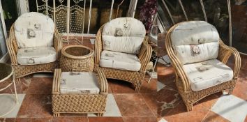 A canework conservatory suite comprising three chairs, table and footstool.