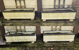 A set of four contemporary cast concrete planters, each 92cm wide.