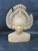 A carved wooden Indo-Asian bust, a/f.