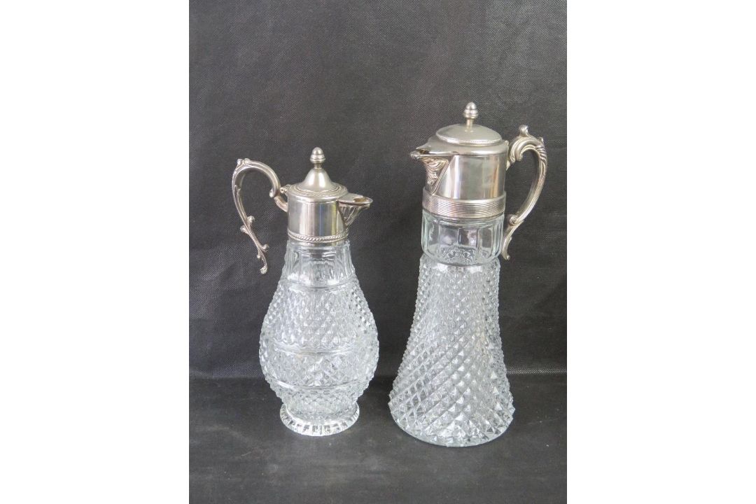 Two glass and silver plated claret jugs.