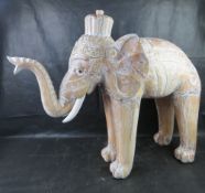 A large and impressive carved wooden elephant standing approx 90cm high.