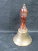 A brass hand bell.