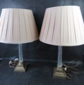A pair of large and impressive brass and glass table lamps with silk shades.
