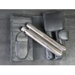 A stainless steel cigar tube and whisky tube set with case and cigar cutter.
