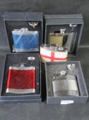 A quantity of stainless steel hip flasks.