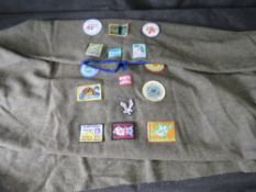 A Scouts poncho having various badges upon.