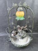 A contemporary bronzed table light and waterfall.