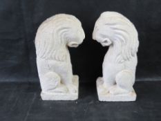 A pair of stone tabletop lions in the Chinese style.