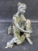 A bronze finished sculpture of a girl with cat to knee by Xaloc (collective of four sculptors),