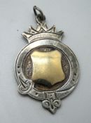 A sterling silver medallion.