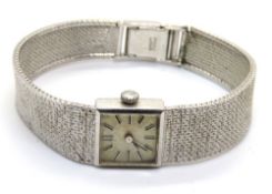 A ladies 9ct white gold Omega wristwatch, square dial with Roman numerals, integral strap,