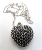 A substantial sapphire set silver heart pendant, stamped 925, 33mm inc bale, on 925 silver chain.