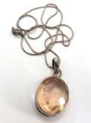 A large pale pink quartz pendant, stampe