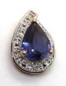 A classic 9ct gold pear cut Tanzanite pendant, white metal halo set with diamonds, hallmarked 375,