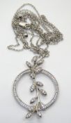 A delightful silver and white stone pendant of floral form, stamped 925, 40mm in length,