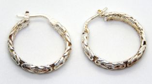 A pair of silver hoop earrings, 24mm drop, stamped 925.