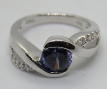A silver blue stone ring, stamped 925, size K.
