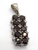 A silver and pendant set with red and white stones, 35mm inc bale, stamped 925.