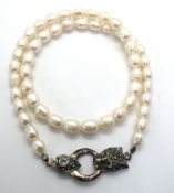 A pearl necklace having 925 silver clasp in the form of a leopard head.