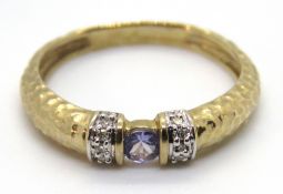 A 9ct gold and tanzanite ring, the band in hammered finish, stamped 9k, size K, 1.7g.