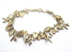 A silver 'charm' bracelet profusely decorated with leaves, butterflies, branches, etc, stamped 925.