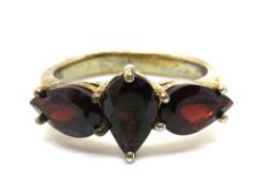A silver and garnet three stone ring, size J.