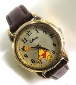 A Disney Winnie the Pooh wristwatch on leather strap.