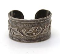 A silver ring with floral pattern, stamp