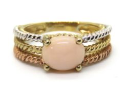 A delightful tri-colour 9ct gold ring having central coral coloured cabachon, hallmarked 375,