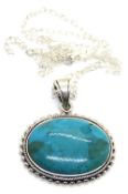 A large silver and turquoise pendant, 35mm wide on silver chain.