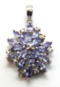 A delightful tanzanite cluster pendant in silver, stamped 925, 27mm inc bale.