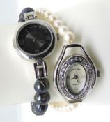 Two ladies wristwatches with pearl straps, white having silver clasp.