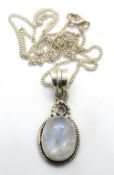 A moonstone pendant on silver chain.