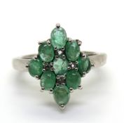 A silver and green stone cluster ring,