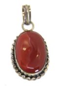 A red hardstone pendant set in white met