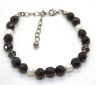 A black stone bracelet having 925 silver clasp.