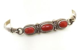 A silver and red hardstone bangle, stamped 925.
