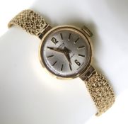 A 9ct gold ladies wristwatch having 9ct gold strap, dial marked for Trebex,