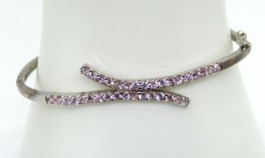 A silver and pink stone bangle, stamped 925.