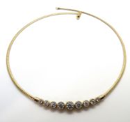 A silver and white stone collar necklace.